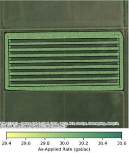 Aerial field map showing alternating application rate strips ranging from 29.4 to 30.6 gallons per acre, illustrating an on-farm fungicide trial design executed via variable-rate prescription.